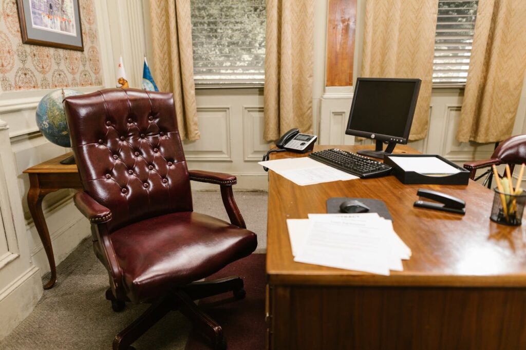 Brown Leather Armchair Beside the Wooden Table